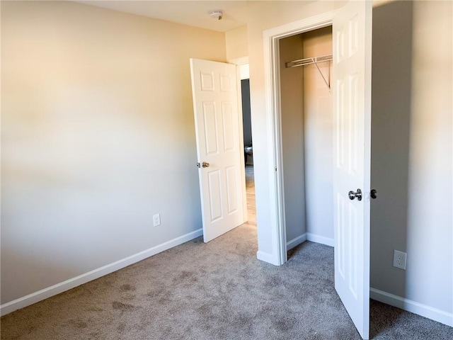 unfurnished bedroom featuring a closet and carpet flooring