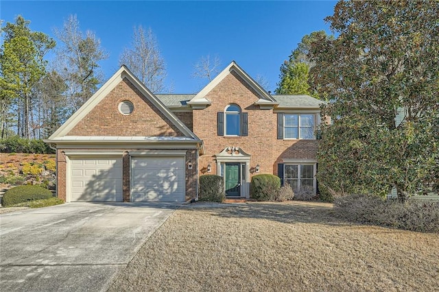 view of front of property with an attached garage, driveway, and brick siding