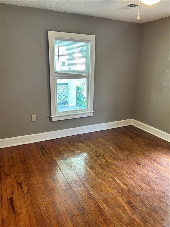 2203 Hillcrest Ave, Decatur, GA 30032 - unfurnished room featuring ceiling fan, a textured ceiling, and dark hardwood / wood-style floors