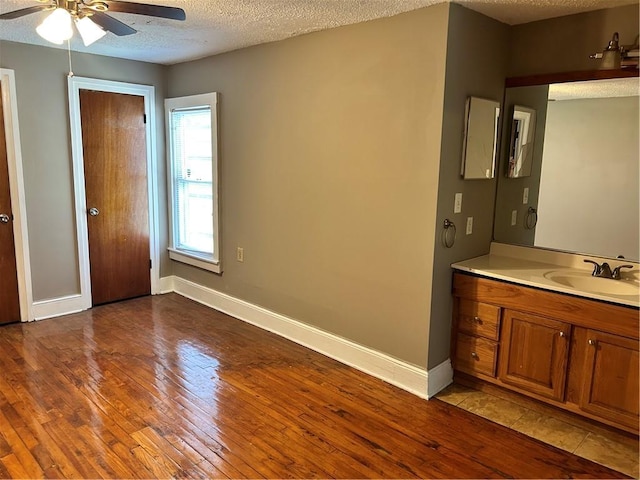 2203 Hillcrest Ave, Decatur, GA 30032 - interior space featuring vanity, ceiling fan, wood-type flooring, and a textured ceiling