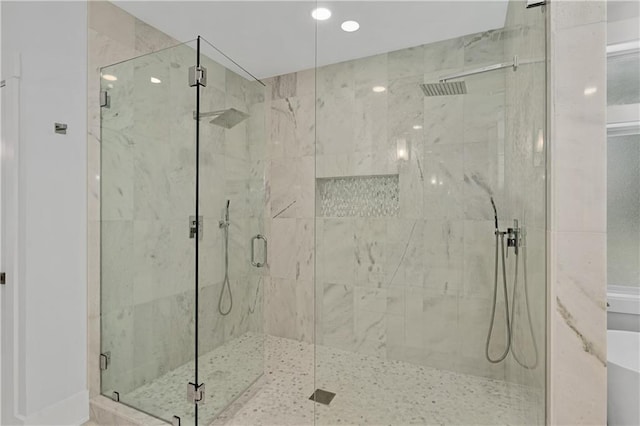 bathroom with a shower with door