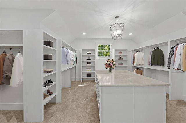 spacious closet featuring an inviting chandelier