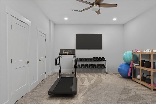 exercise room featuring light colored carpet and ceiling fan