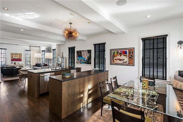 kitchen featuring dishwasher, dark hardwood / wood-style flooring, decorative light fixtures, beam ceiling, and a kitchen island