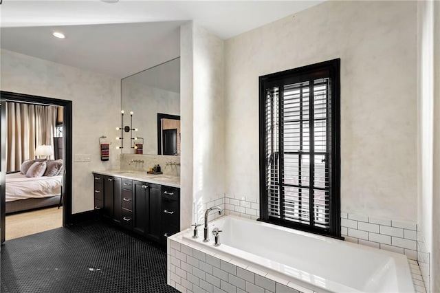 bathroom with a relaxing tiled tub and vanity