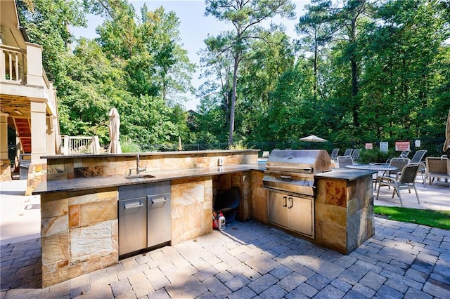 view of patio featuring a grill, sink, and an outdoor kitchen