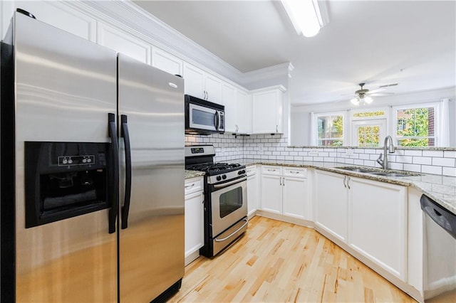 kitchen with sink, white cabinets, and stainless steel appliances