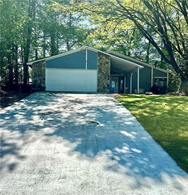1462 Country Downs Dr, Norcross, GA 30093 - view of front of property with an attached garage, driveway, stone siding, and a front yard