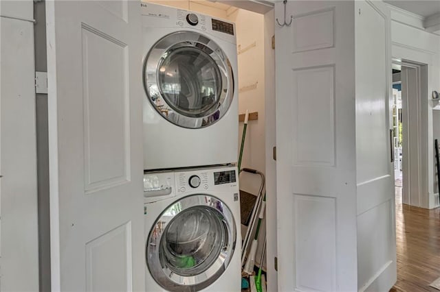 222 Winnona Dr, Decatur, GA 30030 - laundry area featuring stacked washing machine and dryer and wood finished floors
