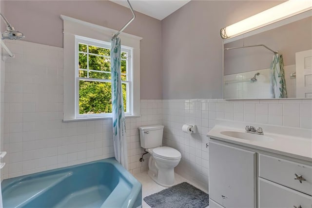 222 Winnona Dr, Decatur, GA 30030 - bathroom with healthy amount of natural light, vanity, shower / bath combo with shower curtain, tile walls, and wainscoting