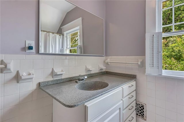 222 Winnona Dr, Decatur, GA 30030 - full bathroom featuring tile walls, vanity, lofted ceiling, and a wainscoted wall