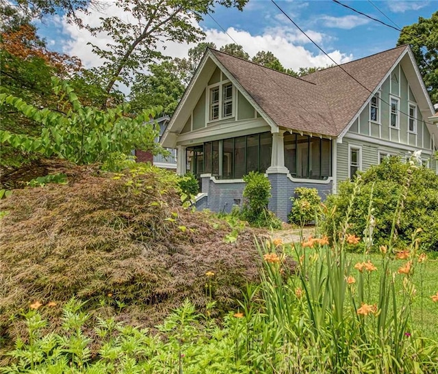 222 Winnona Dr, Decatur, GA 30030 - view of front facade with a shingled roof, a sunroom, and brick siding