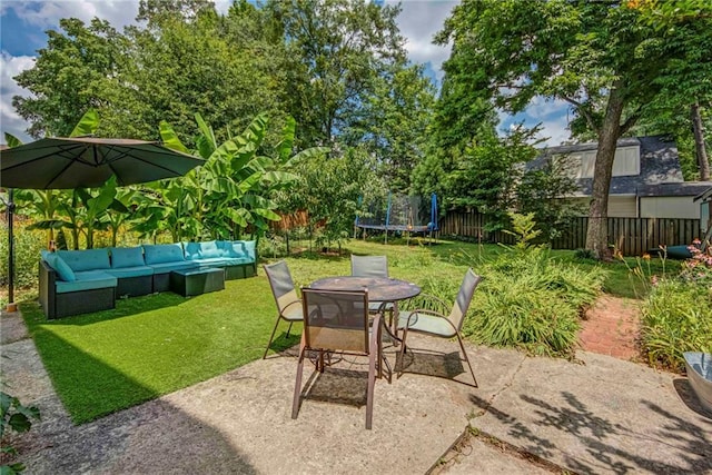 222 Winnona Dr, Decatur, GA 30030 - fenced backyard featuring outdoor lounge area, a trampoline, a patio, and outdoor dining area