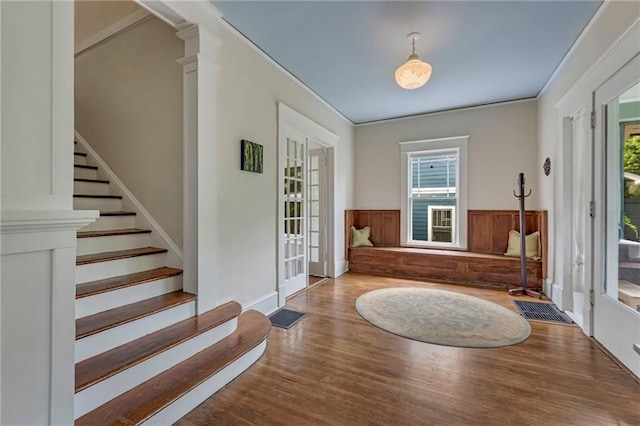 222 Winnona Dr, Decatur, GA 30030 - foyer entrance featuring wood finished floors, a wainscoted wall, stairway, and french doors