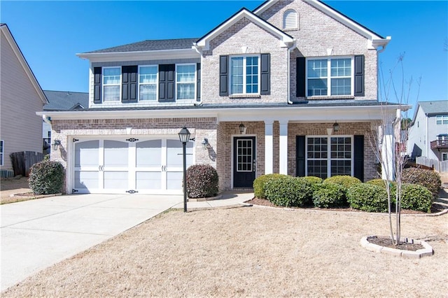 traditional-style home featuring concrete driveway, brick siding, and an attached garage