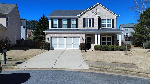 traditional-style home with an attached garage, concrete driveway, and brick siding