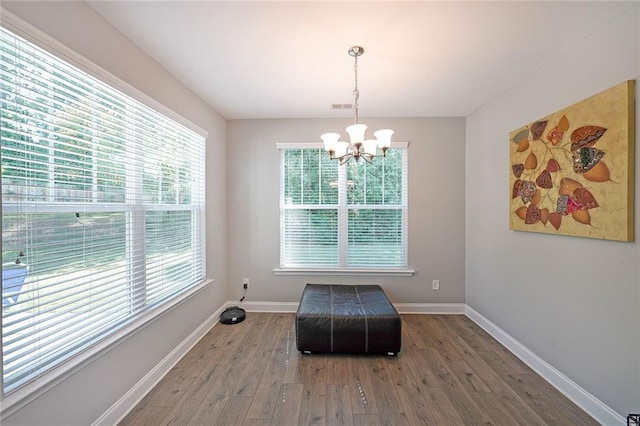 686 Stark St, Lawrenceville, GA 30046 - sitting room with a chandelier, wood finished floors, healthy amount of natural light, and baseboards