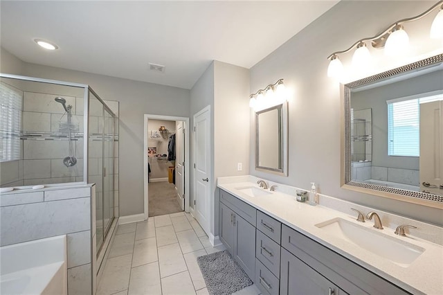 686 Stark St, Lawrenceville, GA 30046 - bathroom with double vanity, a shower stall, a garden tub, and baseboards