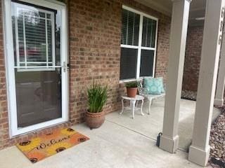 686 Stark St, Lawrenceville, GA 30046 - view of exterior entry featuring brick siding and a porch