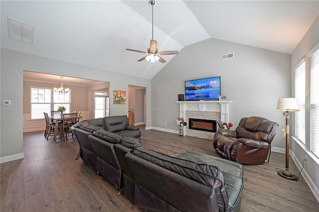 686 Stark St, Lawrenceville, GA 30046 - living area with lofted ceiling, wood finished floors, a glass covered fireplace, ceiling fan, and a chandelier