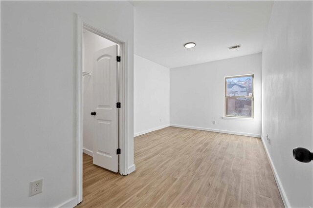 spare room with light wood-type flooring