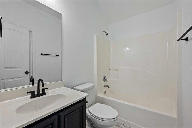 full bathroom featuring vanity, bathtub / shower combination, and toilet