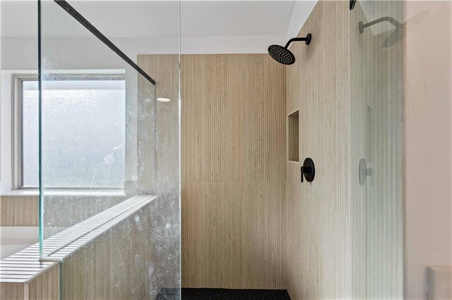 bathroom with tiled shower