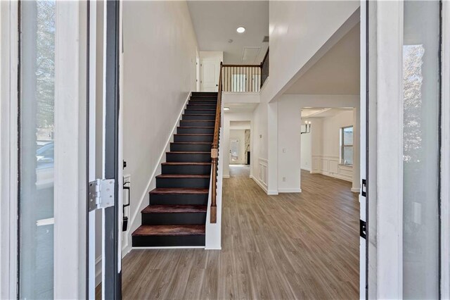 foyer entrance featuring a wealth of natural light and wood-type flooring