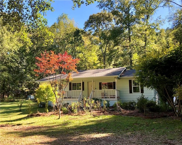 ranch-style house with a porch and a front yard