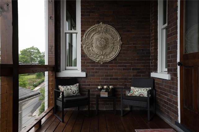 interior space featuring dark wood-style flooring and brick wall