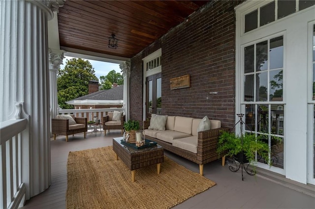 exterior space featuring covered porch and outdoor lounge area