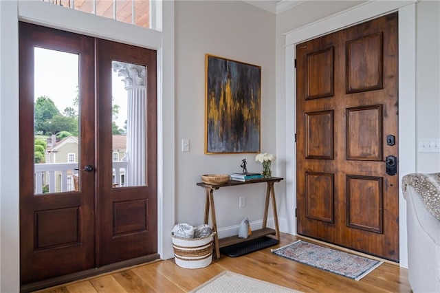 foyer entrance with french doors and light wood-style flooring