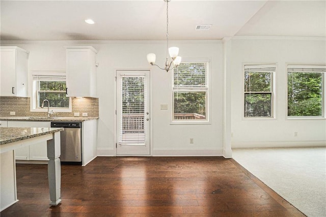 interior space with a sink, dishwasher, white cabinetry, visible vents, and ornamental molding