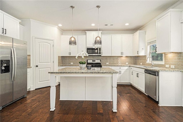 kitchen featuring visible vents, white cabinetry, light stone counters, a sink, and stainless steel appliances