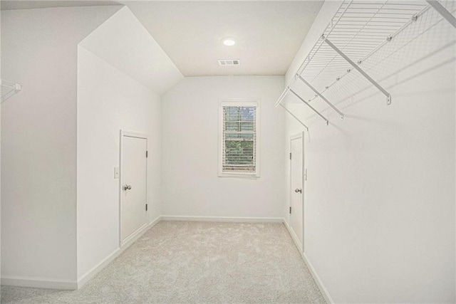 spacious closet featuring visible vents and light colored carpet