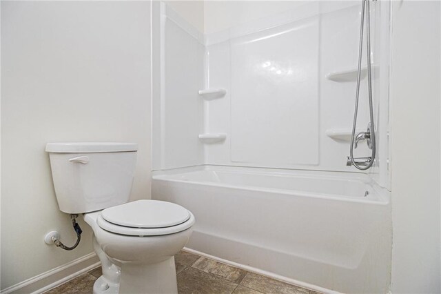 bathroom with baseboards and toilet