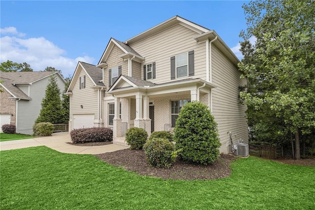 view of front of property with a porch, an attached garage, driveway, and a front yard