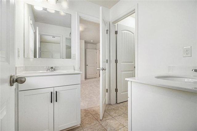 bathroom featuring a sink, tile patterned floors, and two vanities
