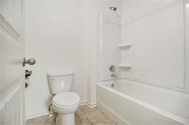 full bath with baseboards,  shower combination, tile patterned flooring, and toilet