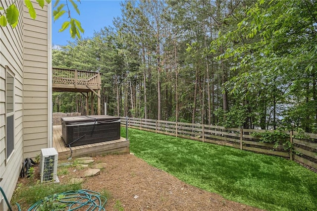 view of yard featuring a fenced backyard, a hot tub, a deck, and central AC unit