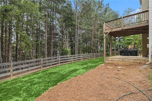 view of yard featuring a fenced backyard, a hot tub, and a deck