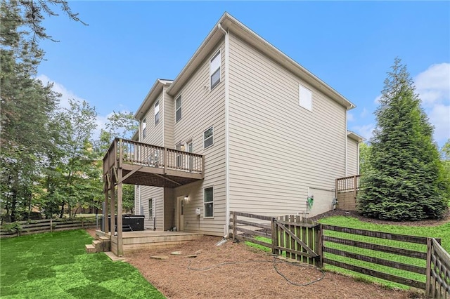 view of side of property featuring fence, a yard, and a deck
