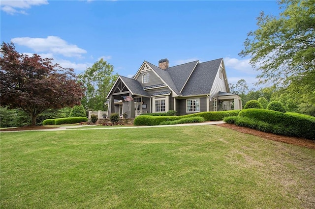 craftsman house featuring a front lawn and a chimney