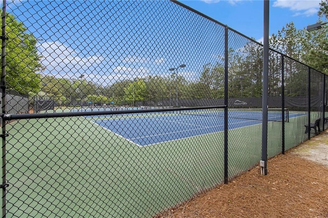 view of tennis court with fence