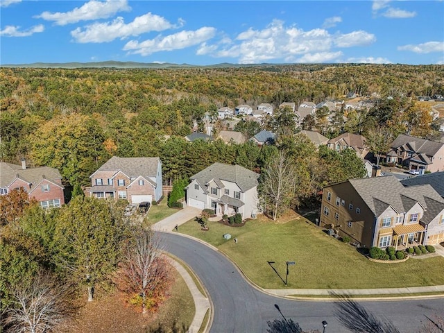 birds eye view of property featuring a residential view and a forest view