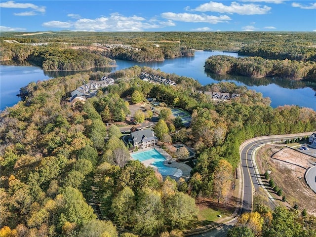 aerial view with a water view and a wooded view