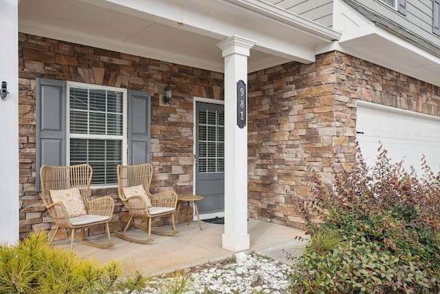 view of patio featuring a garage and covered porch