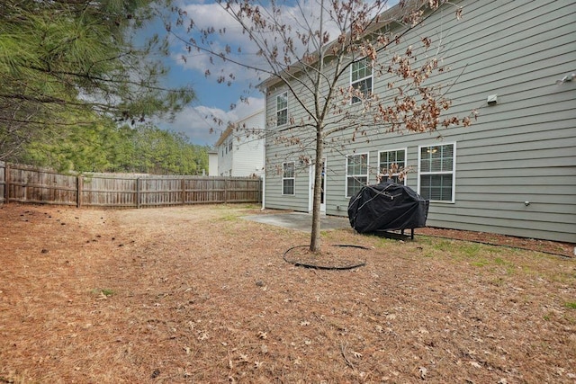 view of yard featuring fence and a patio