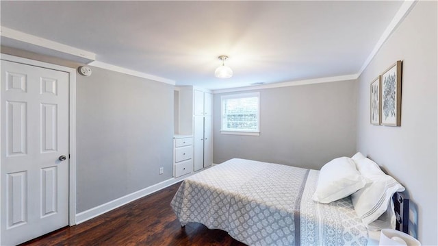 bedroom with crown molding and dark hardwood / wood-style flooring