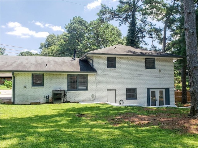 back of house featuring french doors and a yard